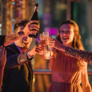 Group of friends on a night out celebrating the new year. They are all having a toast with their glasses of champagne.
